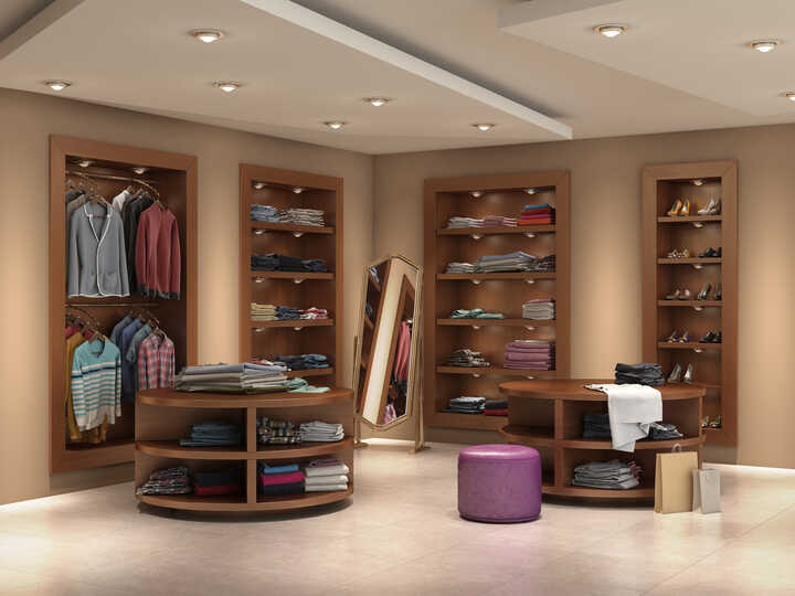 A modern clothing store interior with shelves and a mirror, featuring various garments.