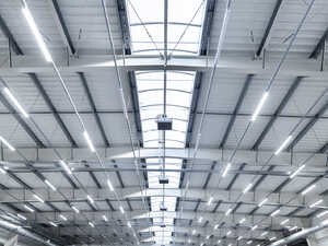 High ceiling of a modern industrial space with bright overhead lights.