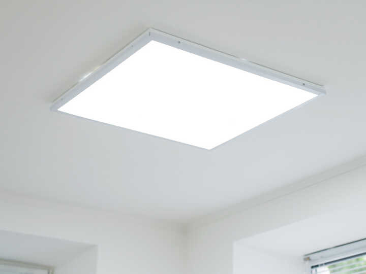 Rectangular ceiling light fixture in a bright, minimalistic room.
